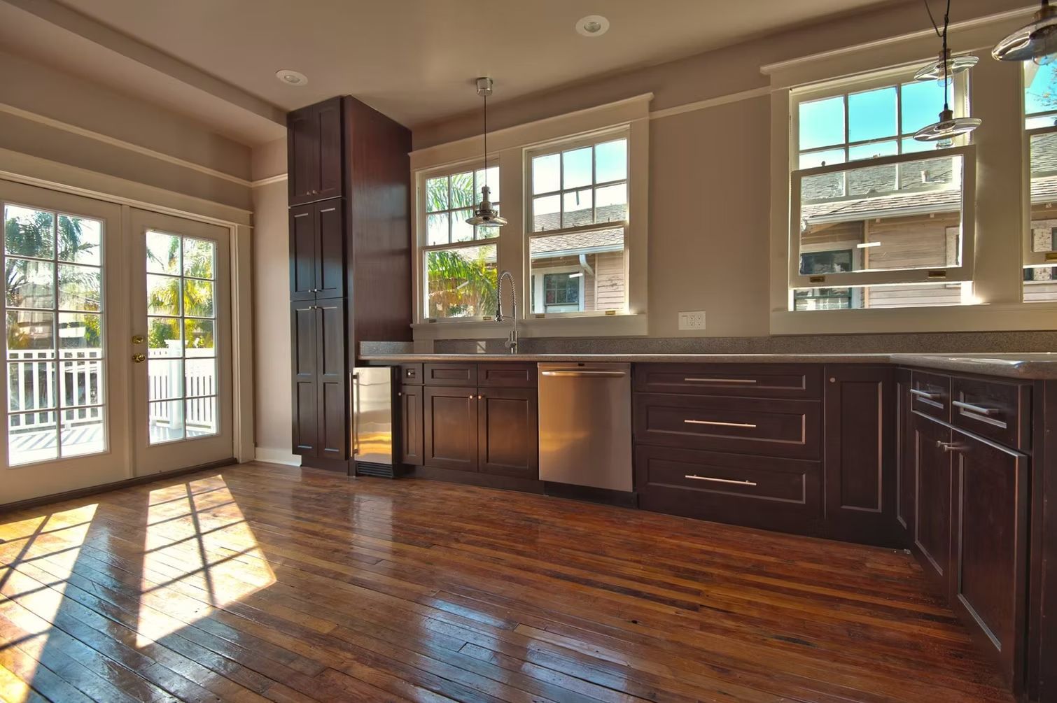 A kitchen with wooden cabinets, stainless steel appliances, and a stove with drawers open.