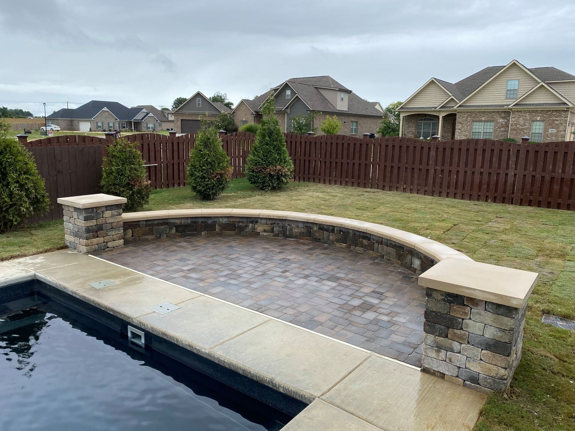 there is a swimming pool in the backyard of a house
