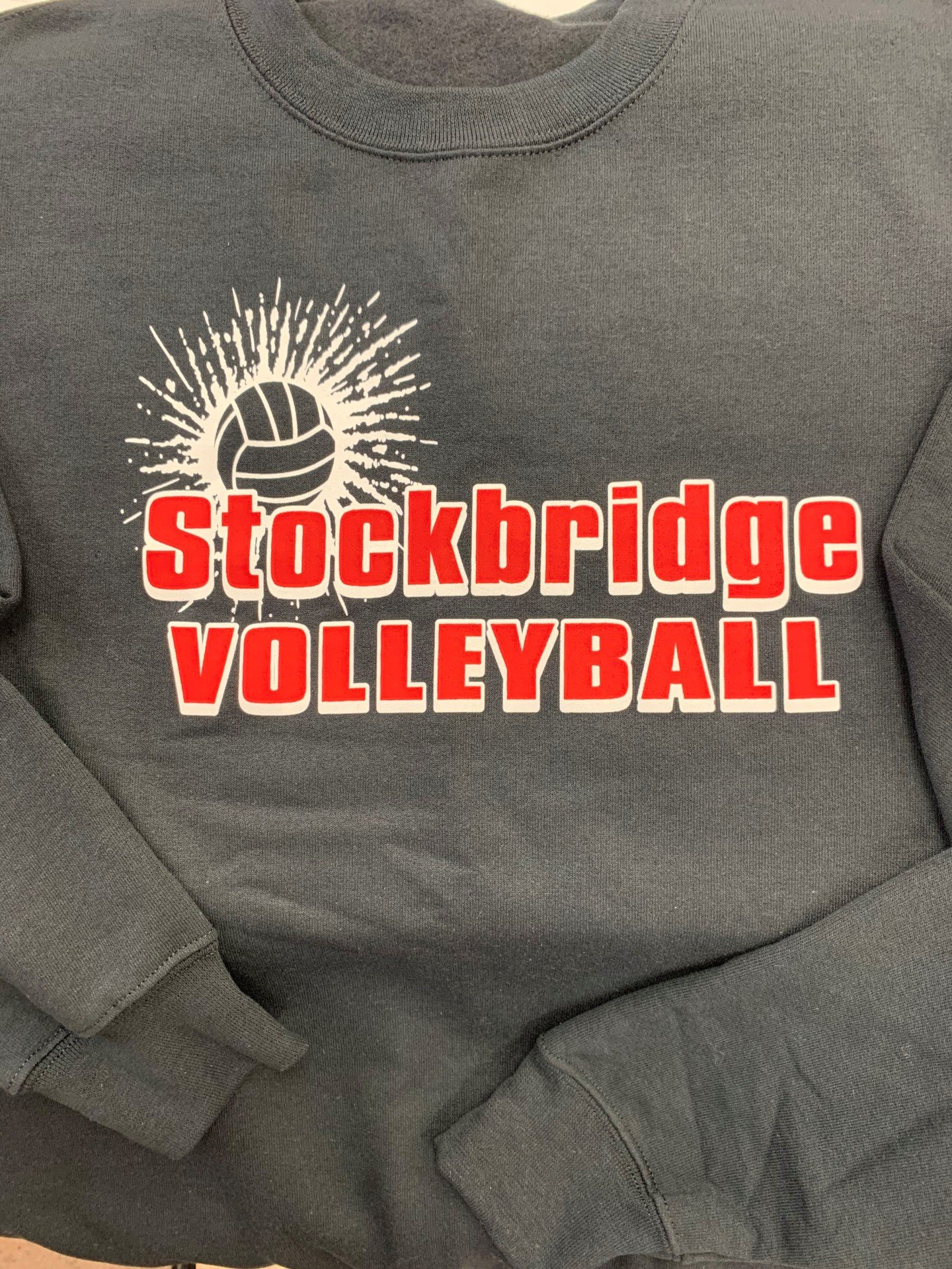 A gray sweatshirt with the words stockbridge volleyball on it