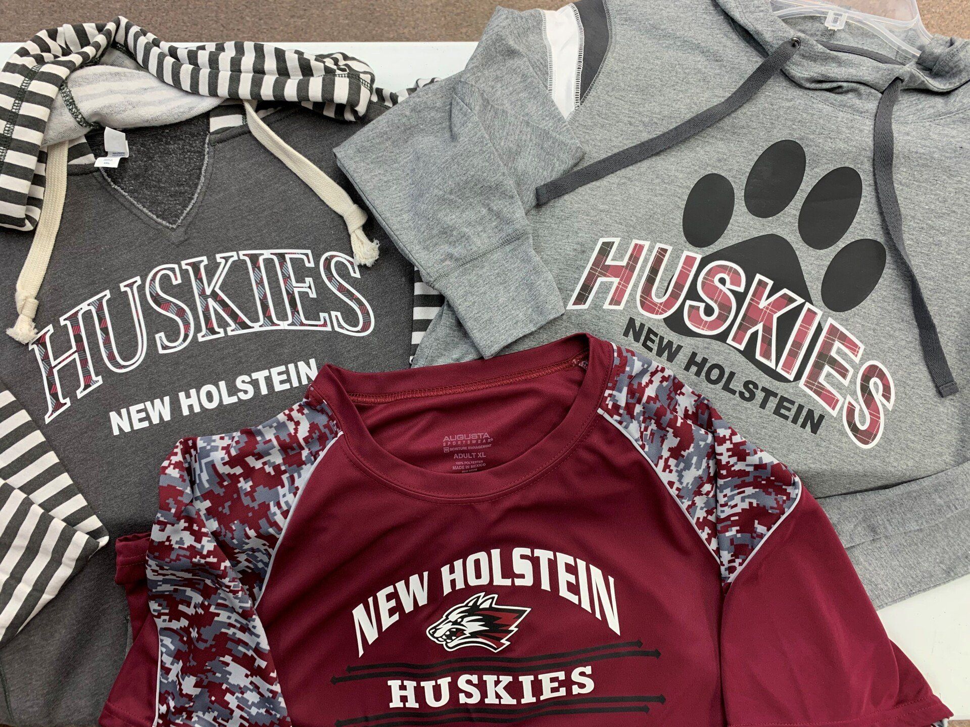A bunch of shirts with the word huskies on them