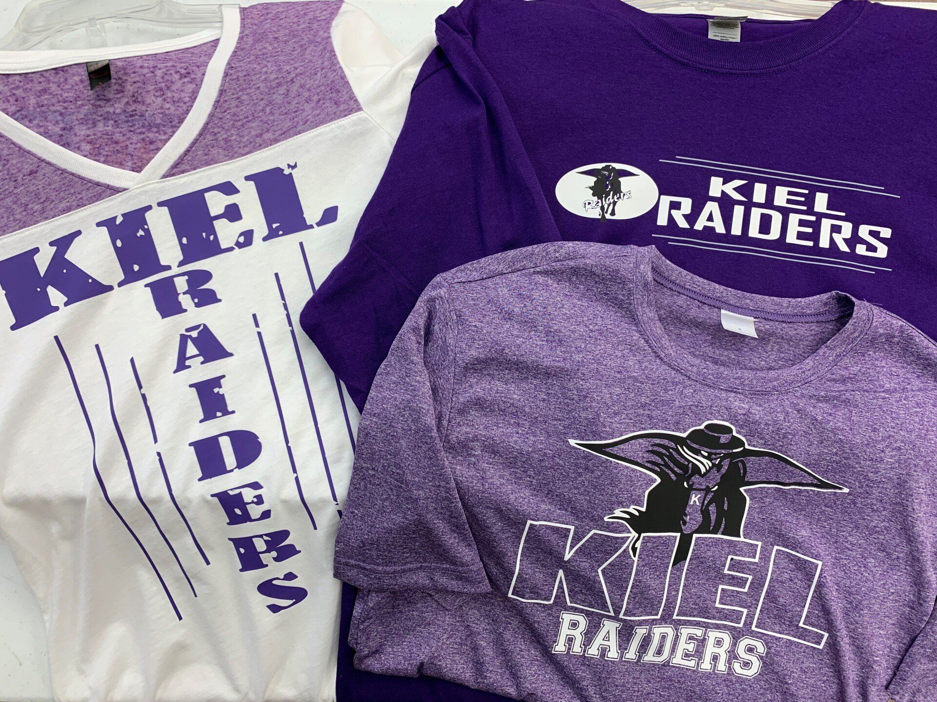 Three shirts with the word raiders on them