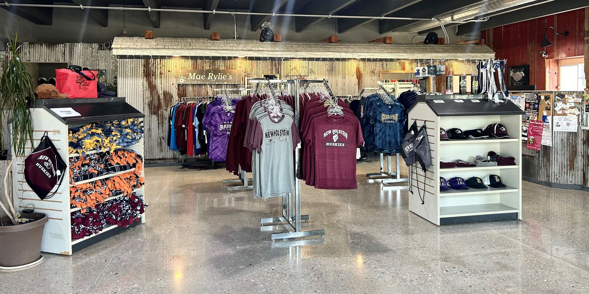 A store filled with lots of shirts hanging on racks.