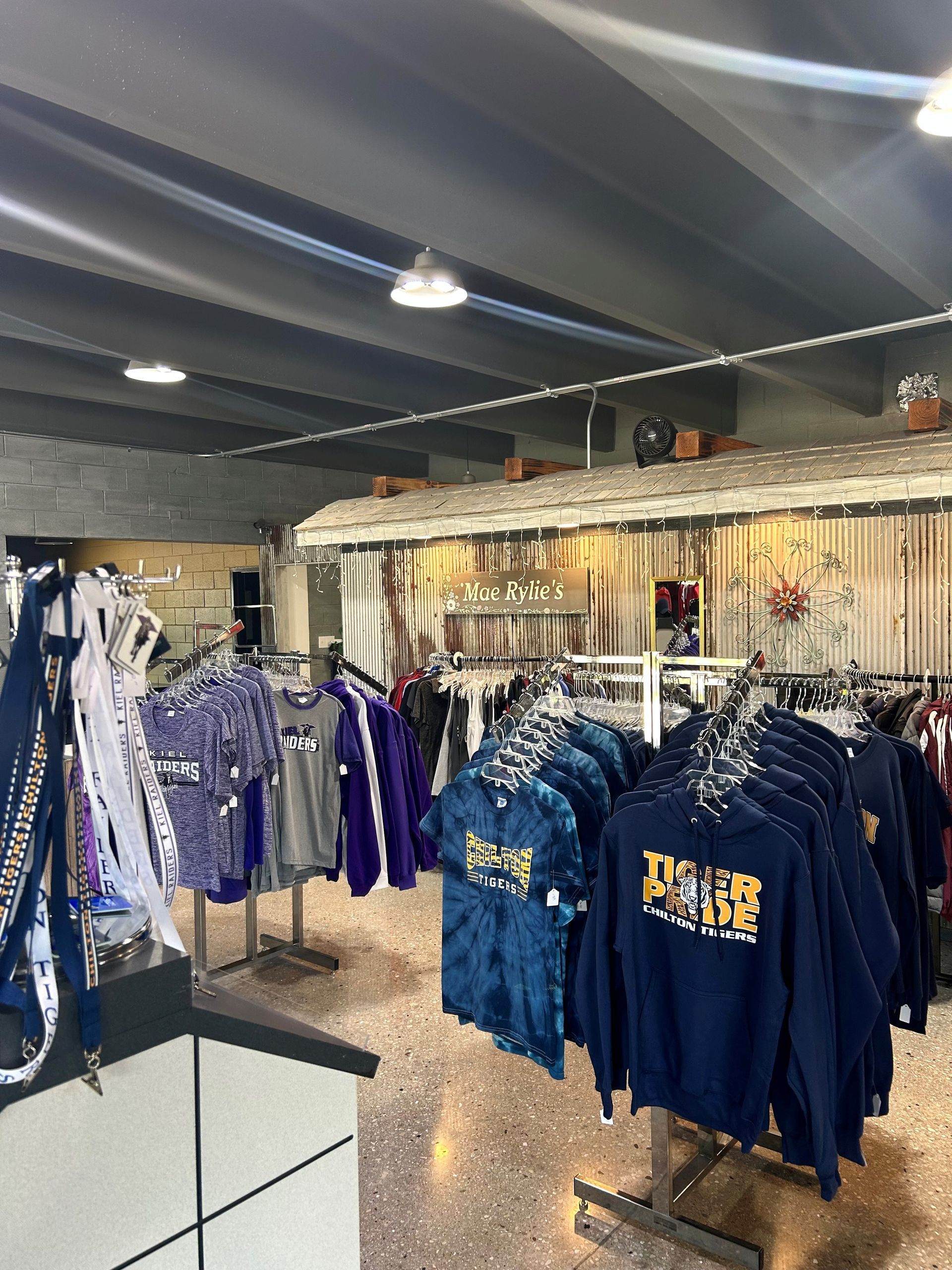 A store filled with lots of shirts hanging on racks.