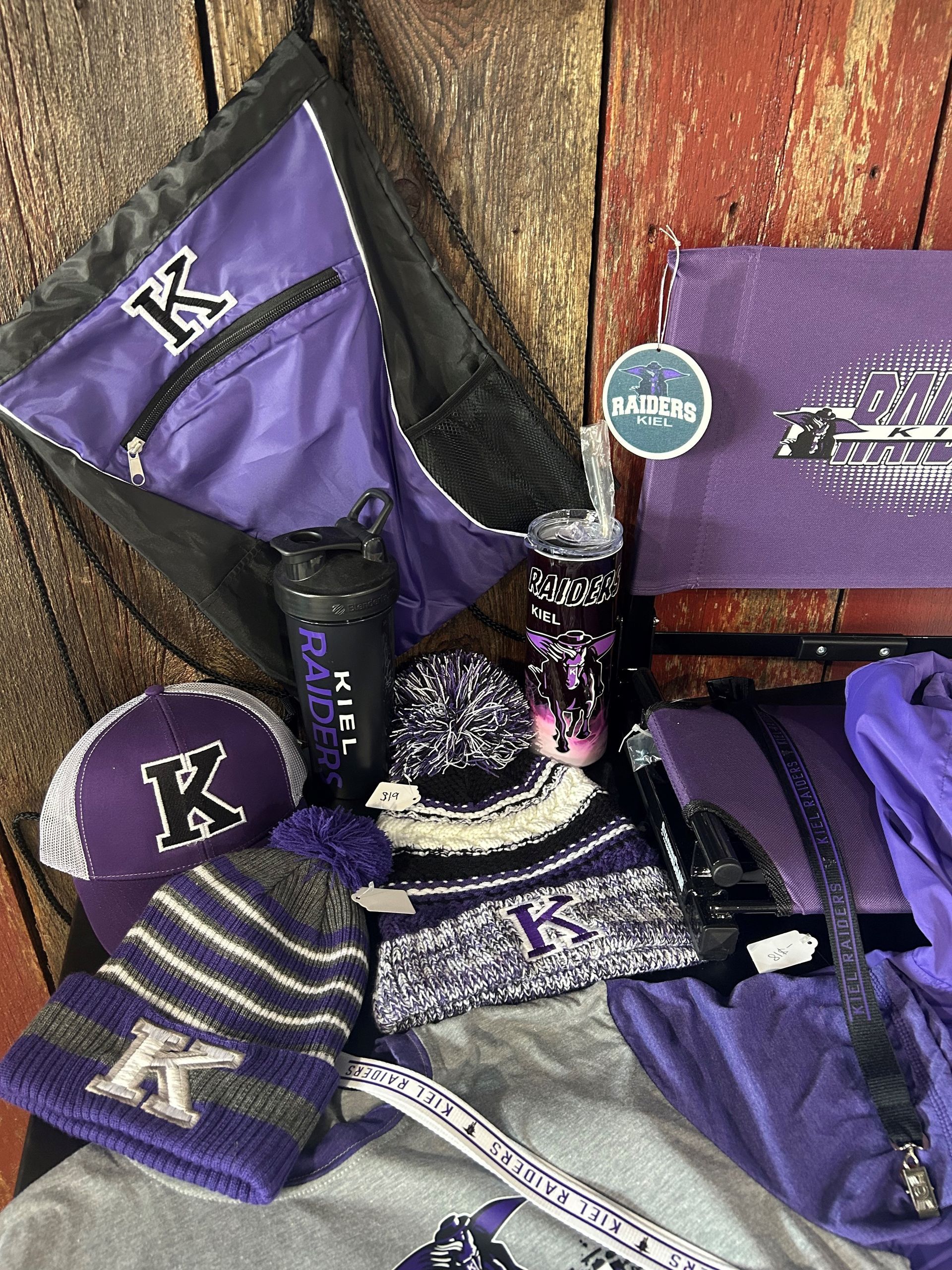 A bunch of purple items are sitting on a wooden table.