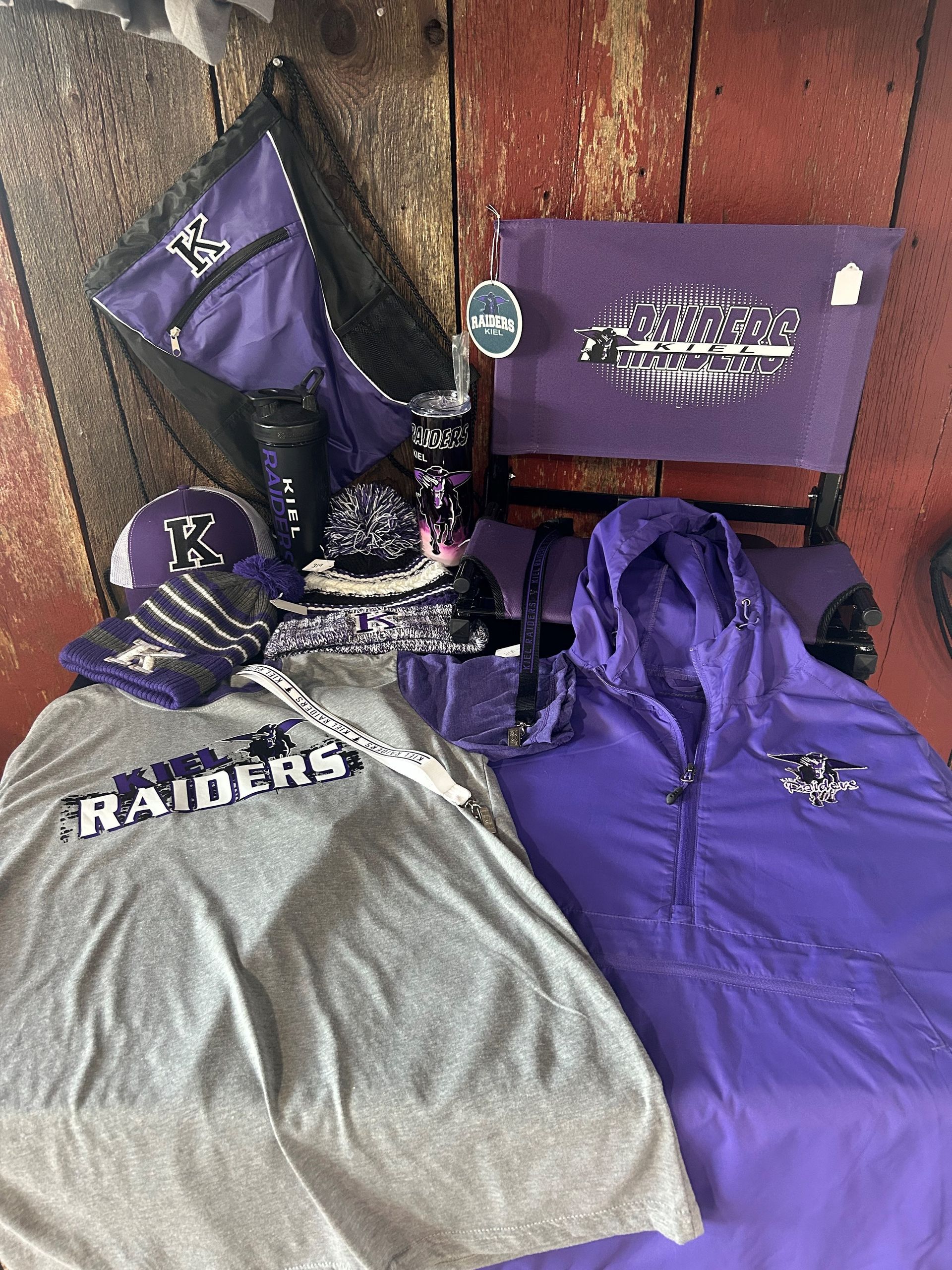 A bunch of raiders clothes are sitting on a wooden table.