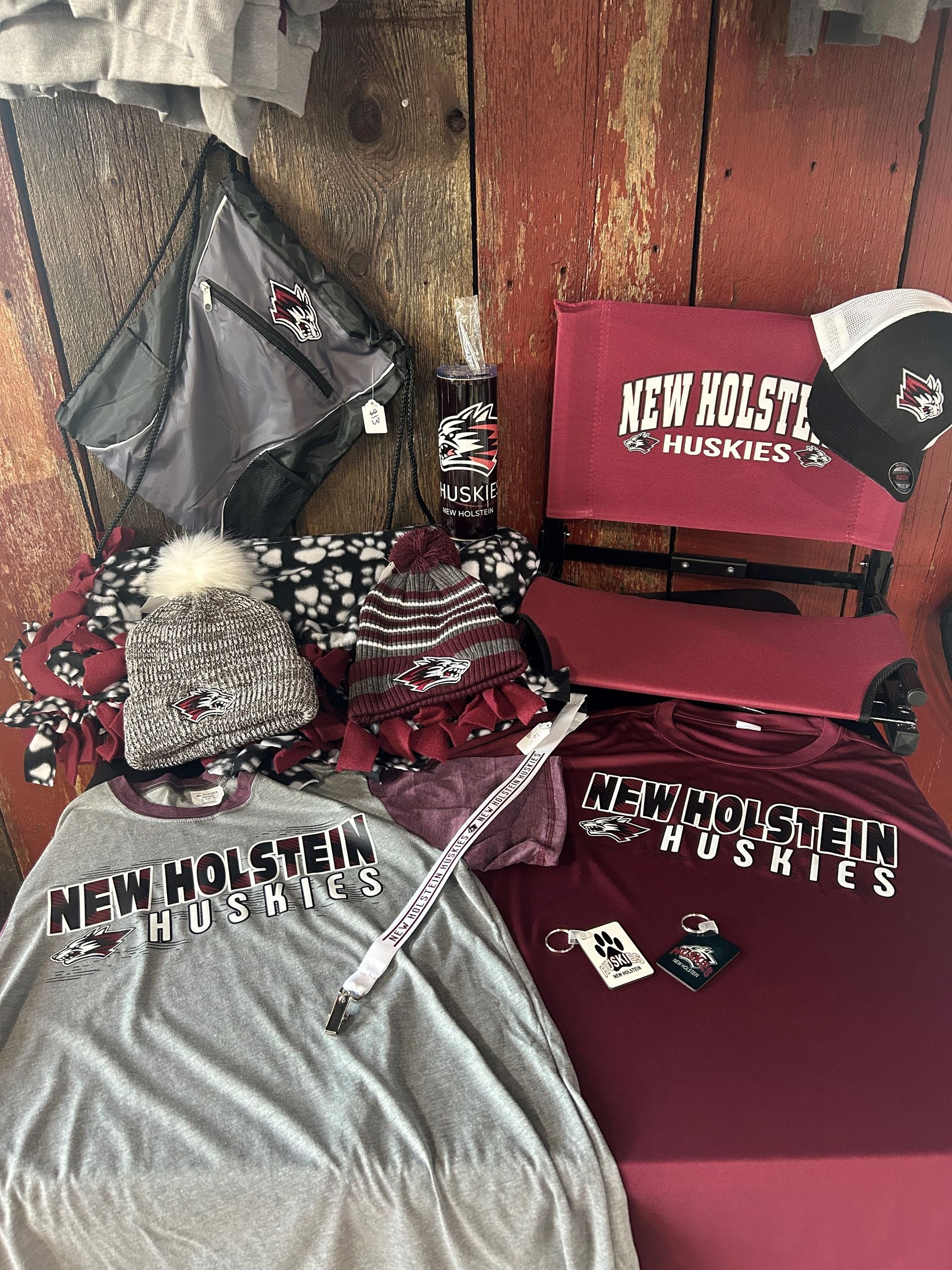 A bunch of shirts and hats are sitting on a table.