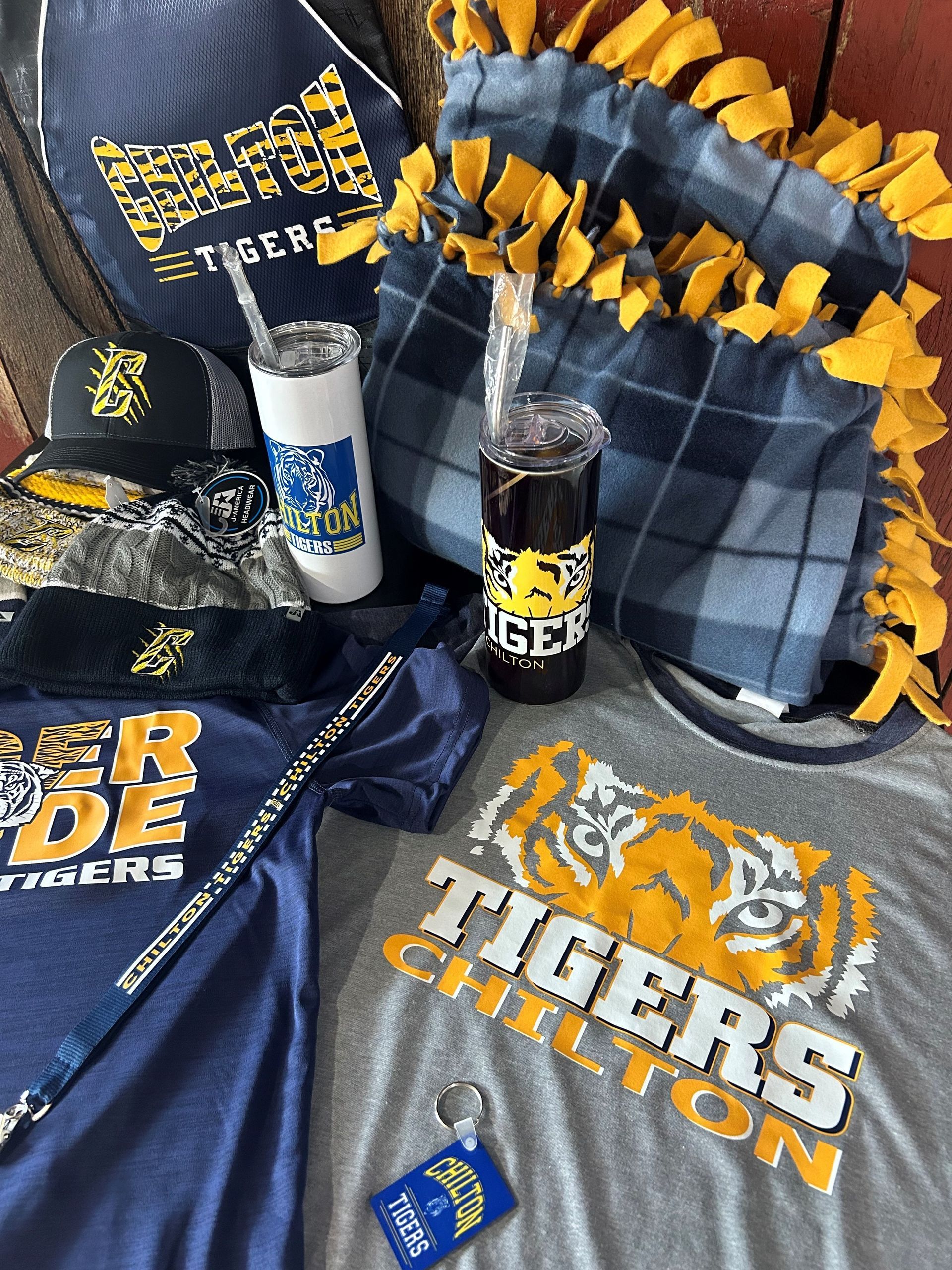 A bunch of tigers stuff is sitting on a couch.