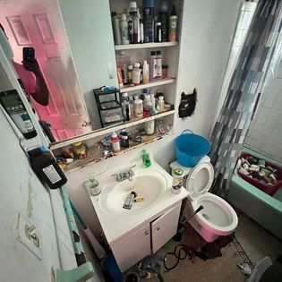 a bathroom with a sink a toilet and a mirror