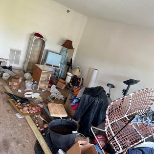 a living room filled with lots of furniture and boxes