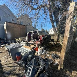 a junkyard with a van sitting in the middle of it