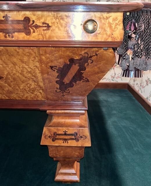 A pool table with a green cloth and a wooden frame