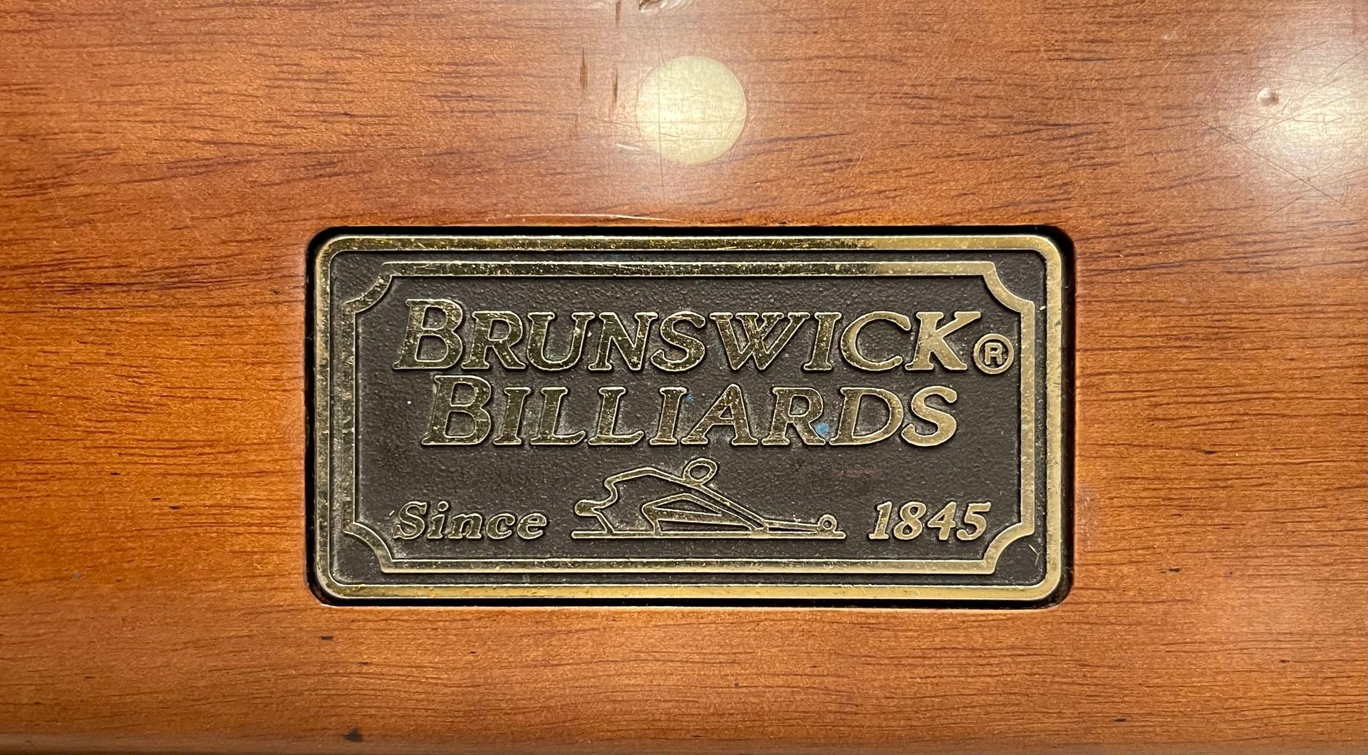 A pool table with balls and cues on it