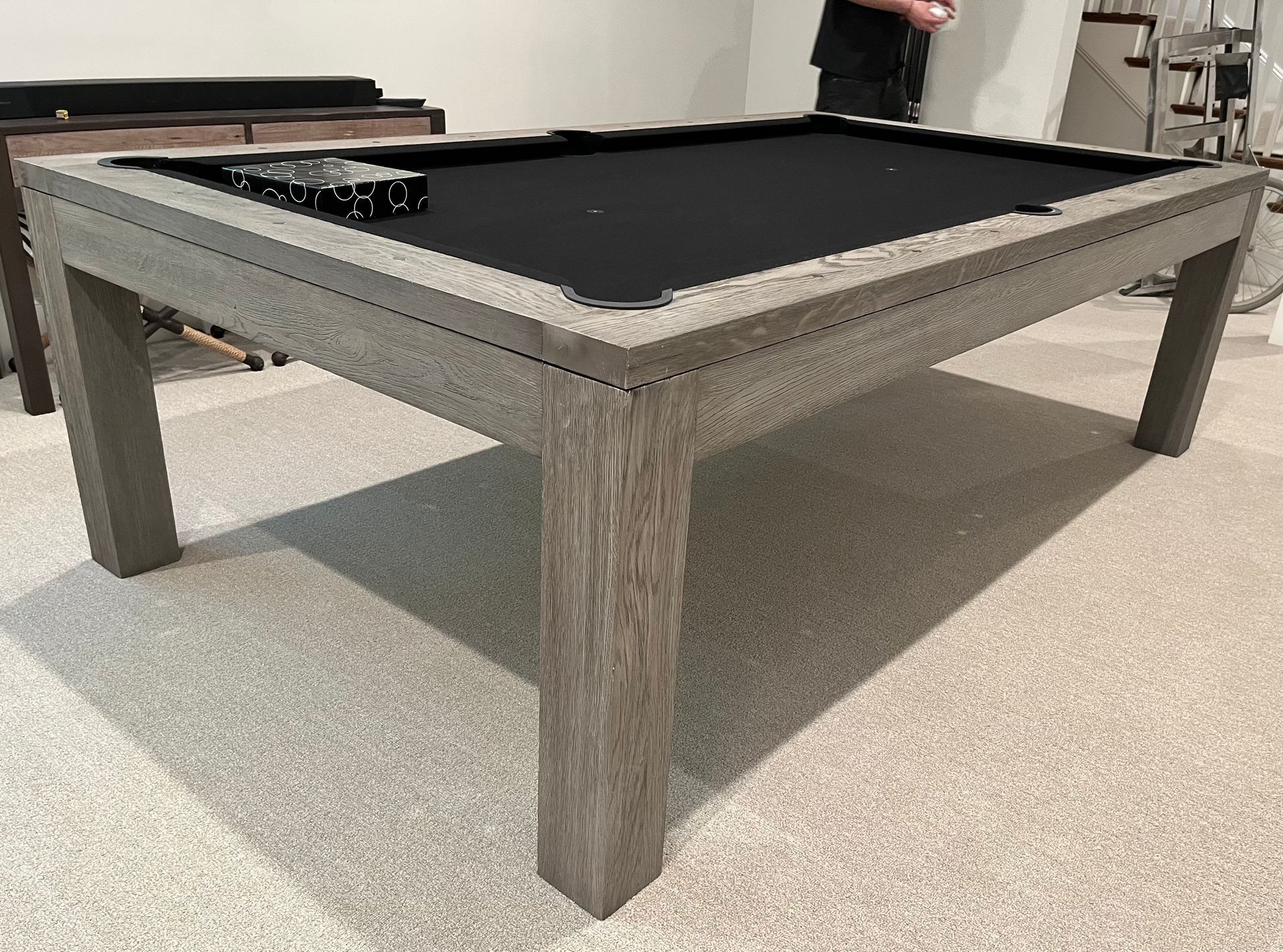 An 8' Olhausen Drake pool table is sitting on a tiled floor in a room.