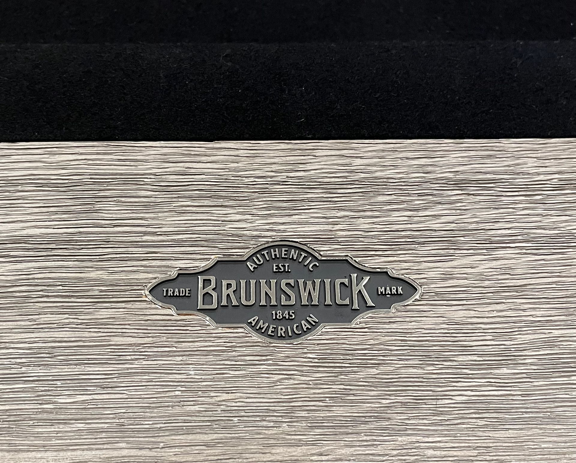 An 8' Olhausen Drake pool table is sitting on a tiled floor in a room.
