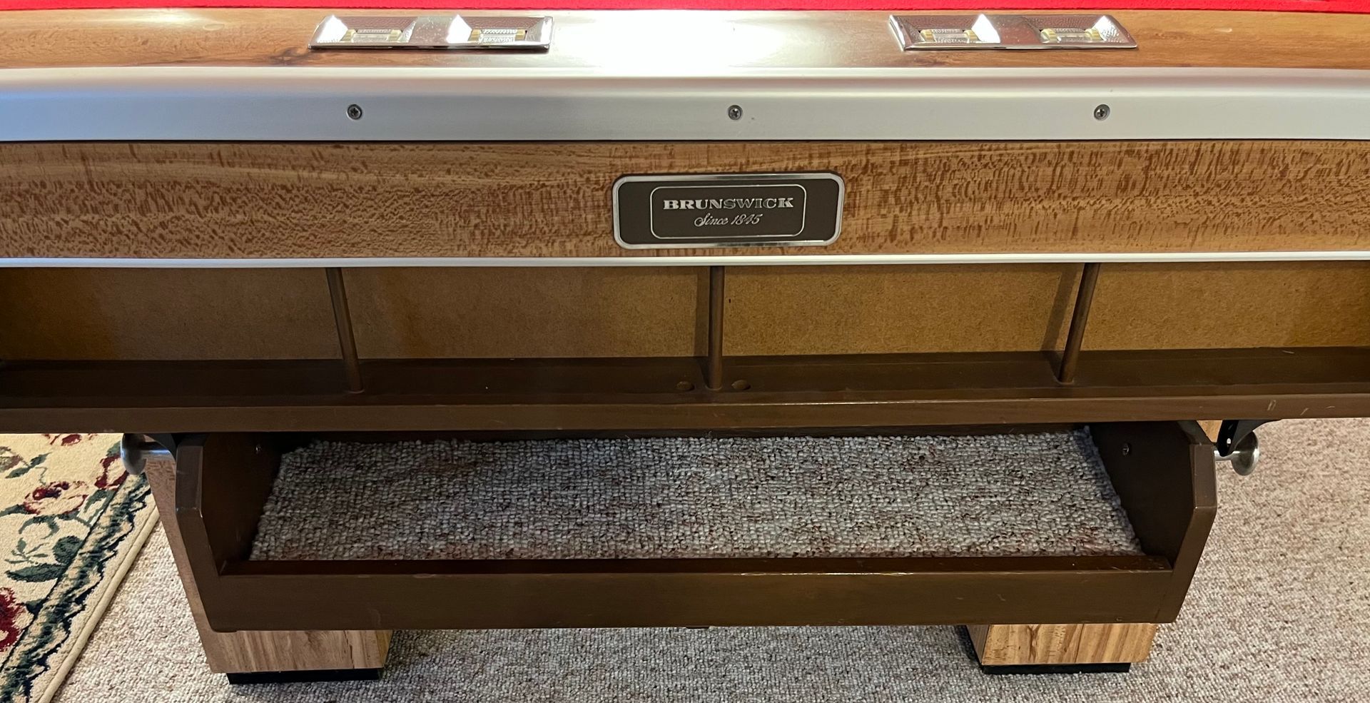 Vintage upright piano with wood finish and a matching bench on a carpeted floor.