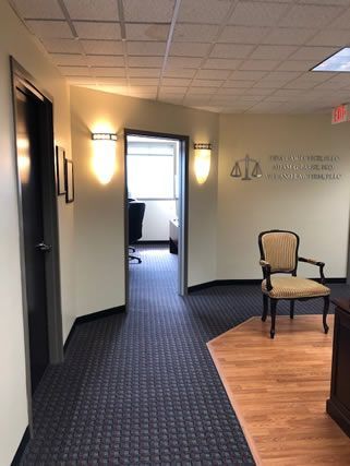 A hallway with a chair and a sign on the wall that says justice