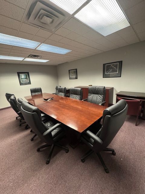 A conference room with a long table and chairs