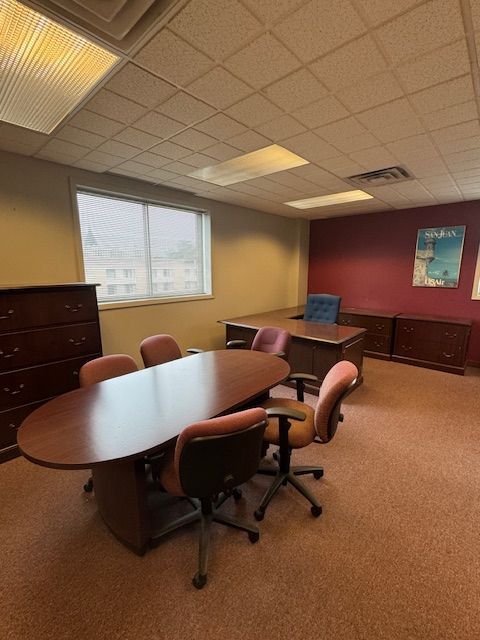 A conference room with a large table and chairs