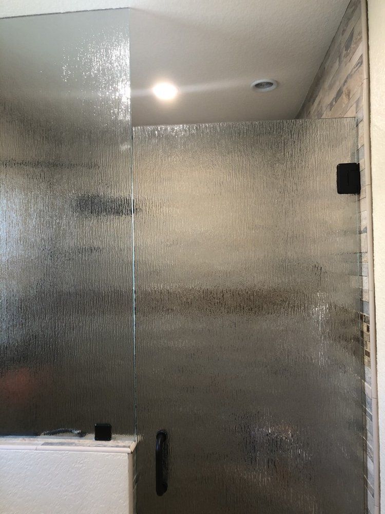 A bathroom with a walk in shower and a bathtub.