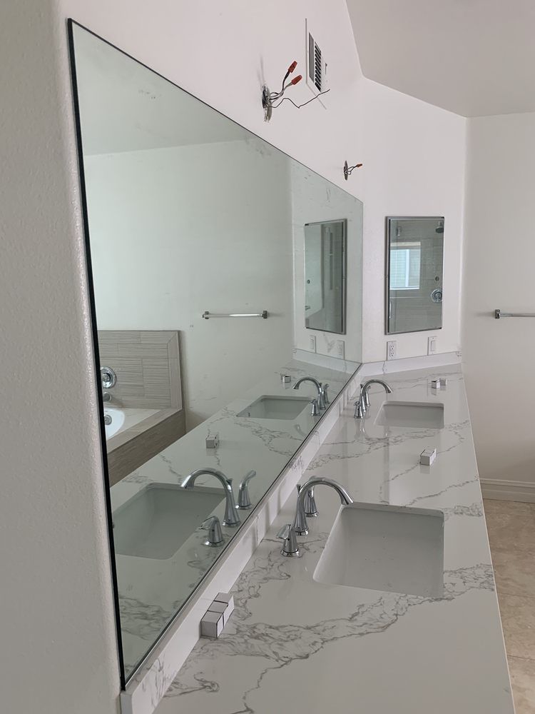 A bathroom with two sinks and a large mirror.