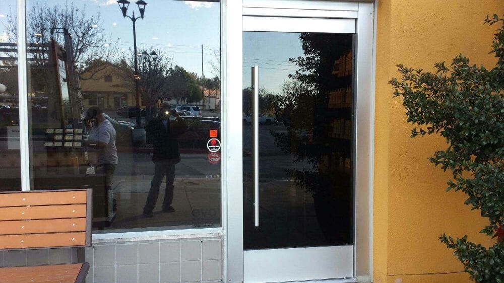 A glass door with a wooden bench in front of it