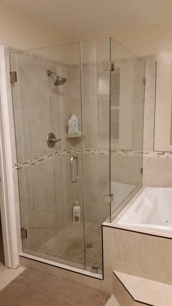 A bathroom with a walk in shower and a bathtub.