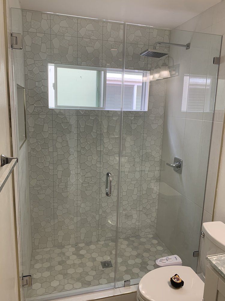 A bathroom with a walk in shower and a toilet.