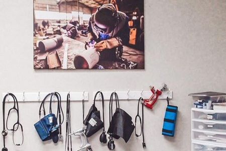 A picture of a man welding hanging on a wall