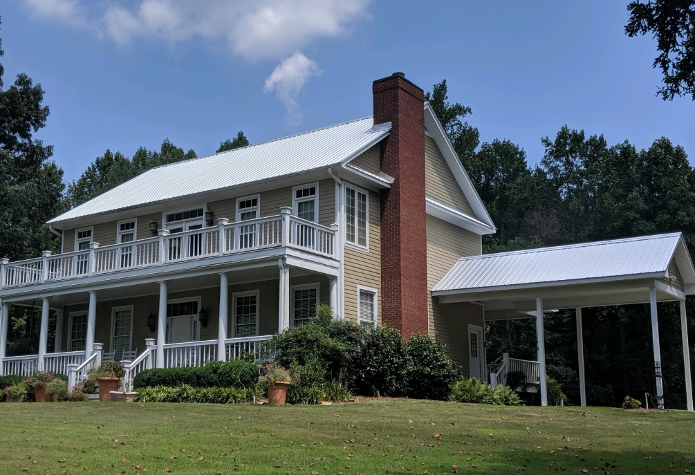 A large house with a white roof and a large porch