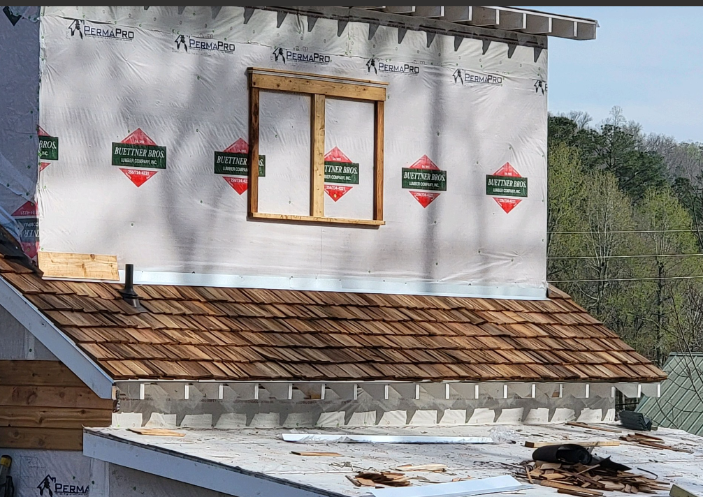 A house is being built with a roof and a window.
