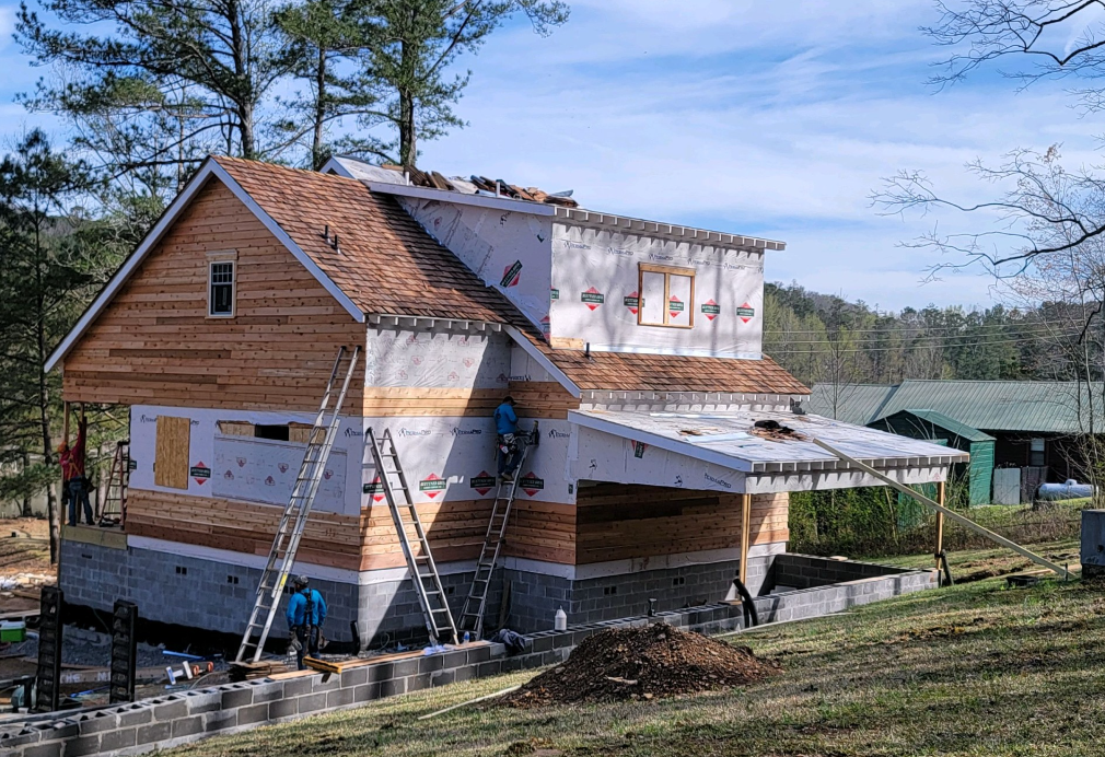 A house is being built in the middle of a field.