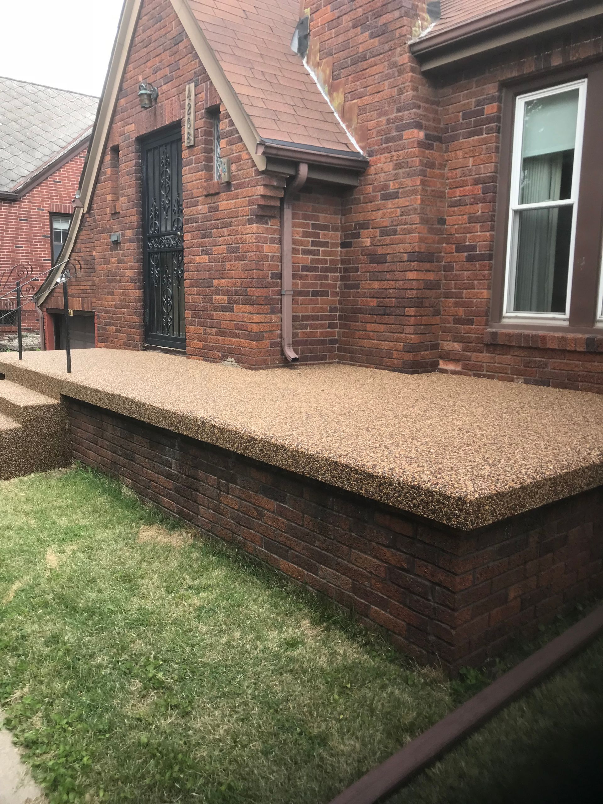 Hand holding a small, stone-covered object as water flows through it, creating dripping effect.