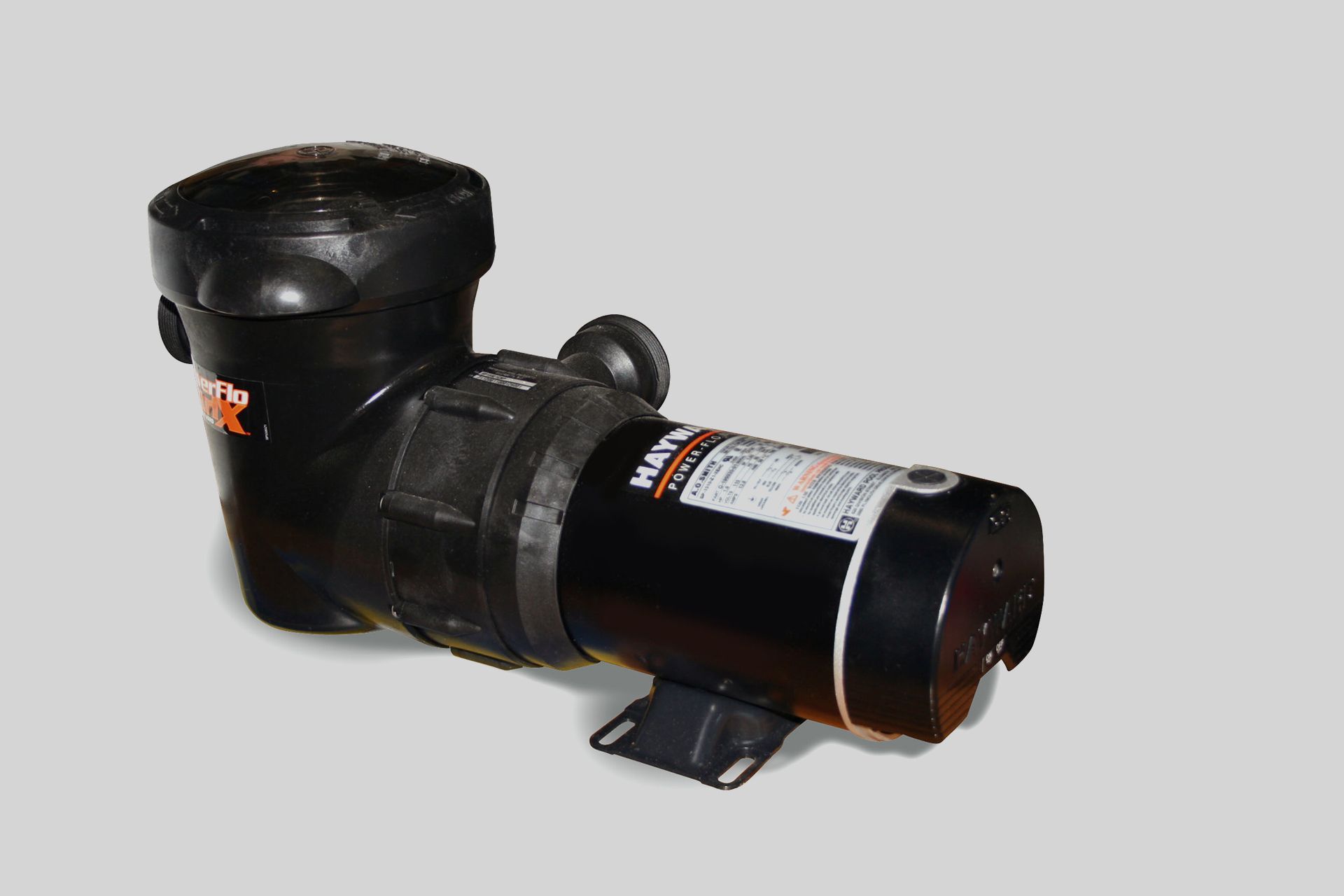 Black cylindrical pump or motor unit with a label on a light gray background