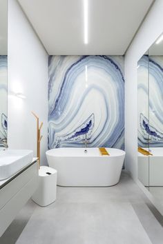 A bathroom with a bathtub , sink and mirror.