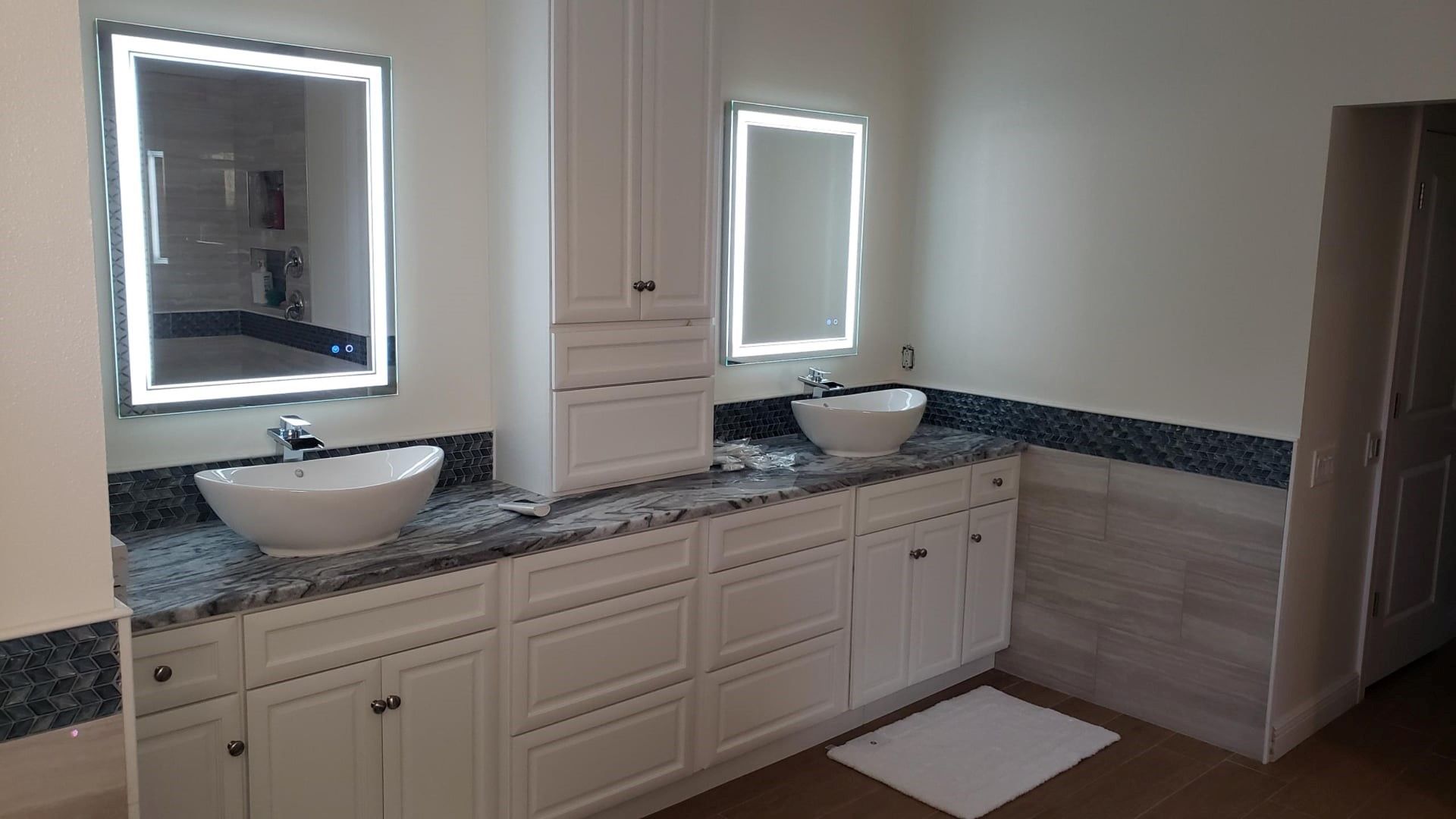A bathroom with two sinks and two mirrors.