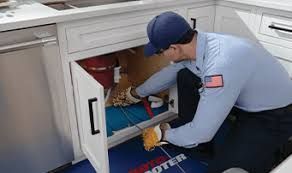 man doing cleaning under a sink