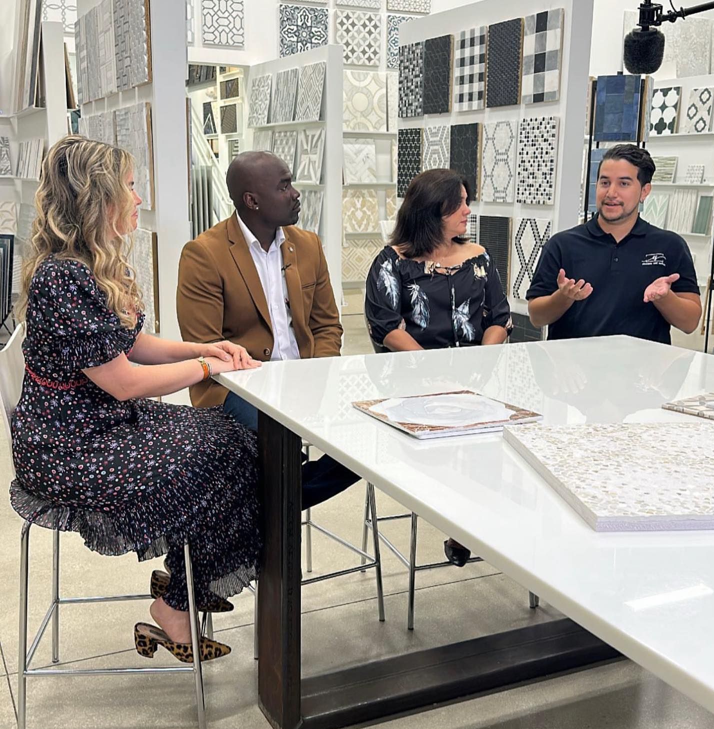 A group of people are sitting around a table talking