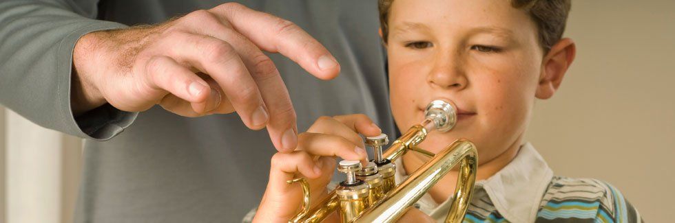 Boy practicing how to play the trumpet