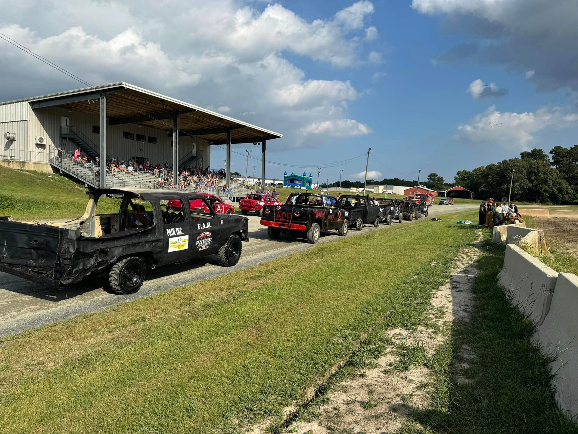 A row of jeep 's are parked on the side of a road.
