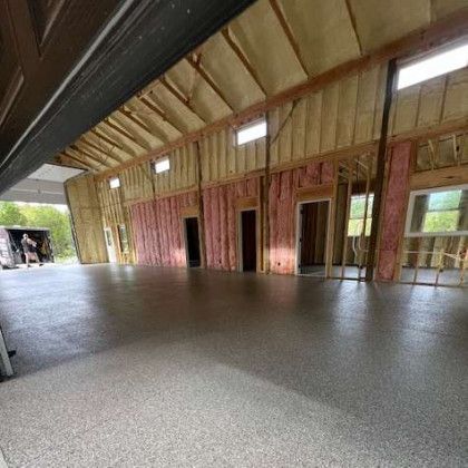 A large empty garage with a concrete floor and walls.