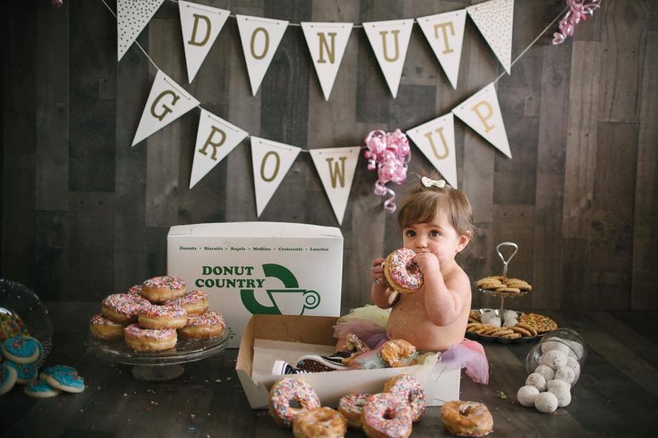 Baby girl eating donuts