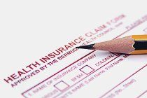 Health insurance claim form and a pencil