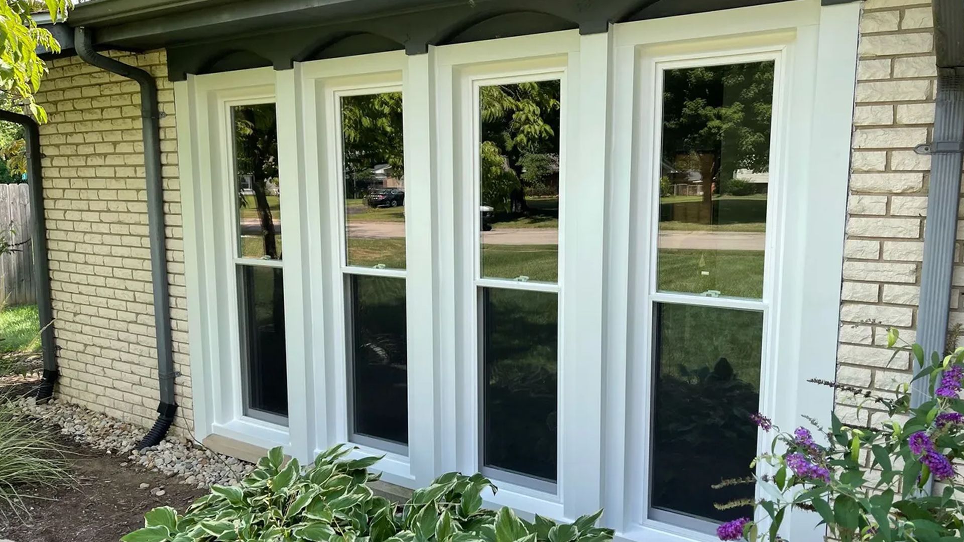 A house with a lot of windows and a gutter on the side of it.
