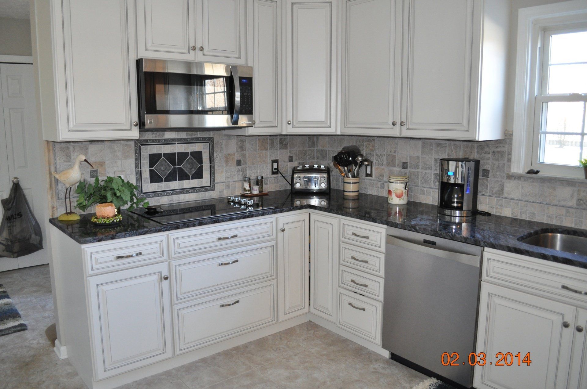 black marble countertop with white cabinetry