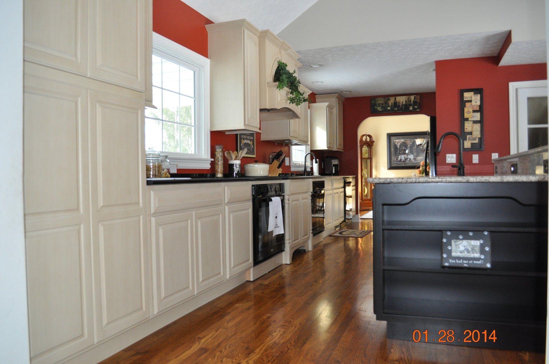 terracota wall kitchen with white cabinetry