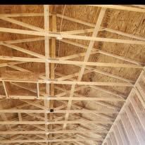 Wooden roof trusses under construction.