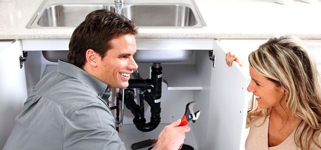 Plumber fixing sink pipe for customer