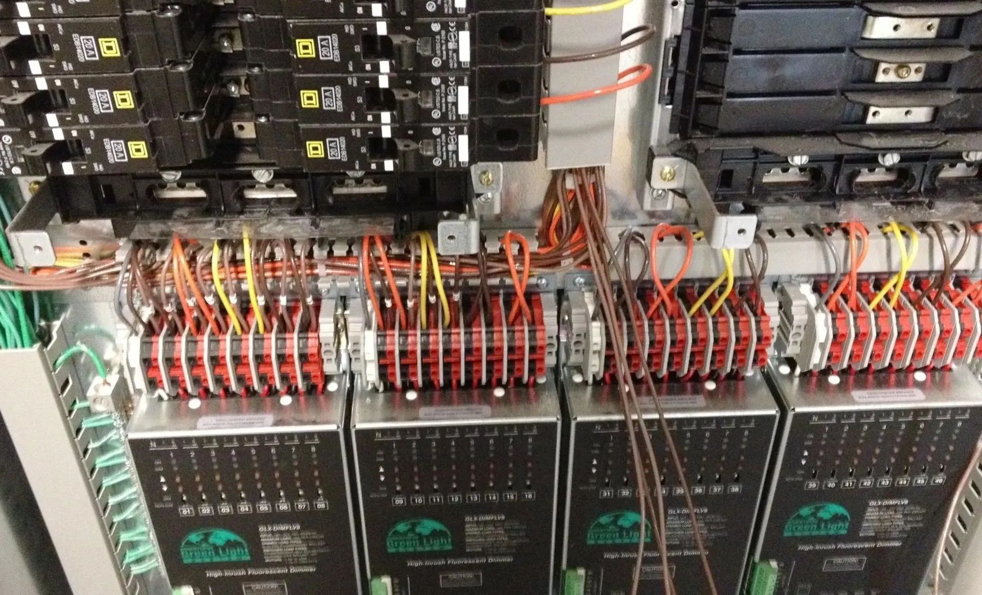 Electrical panel with many wires connected to circuit breakers.