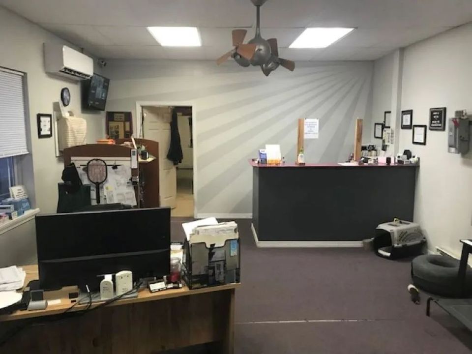 An office interior featuring a desk, reception area, and a ray-like design on the wall.