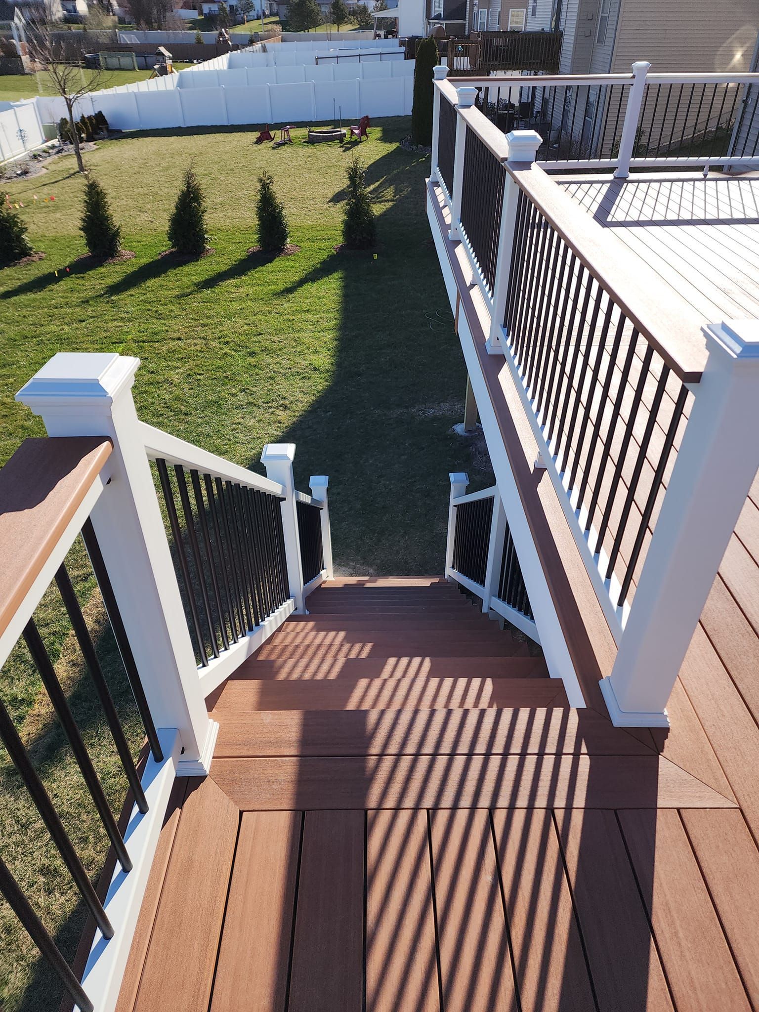 Stairs leading up to a deck with a white railing